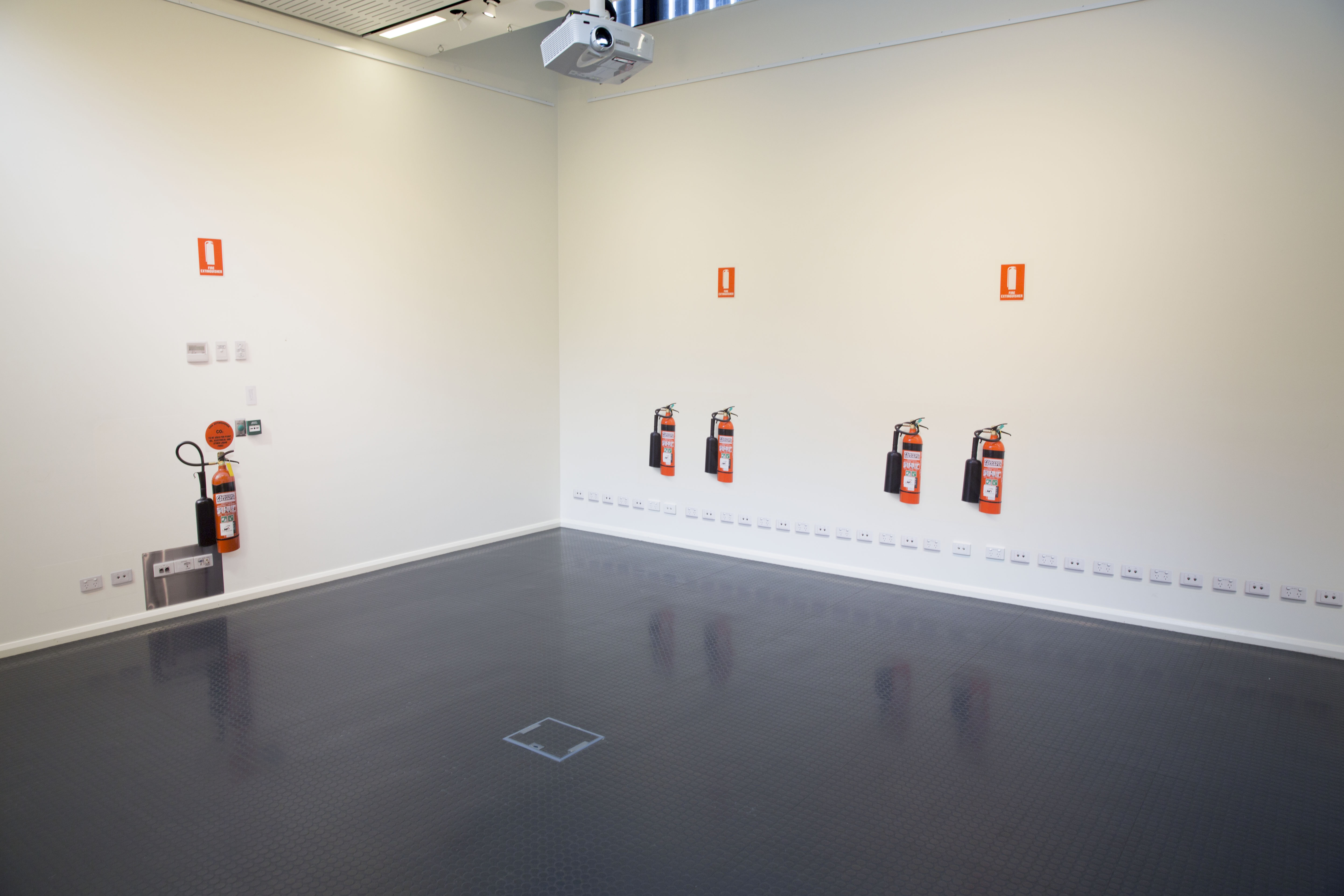 Figure 28: "Untitled Digital photographs, hexachrome print on phototex. Fire extinguishers repeated, same-scale. Gallop Gallery, CSU, Wagga Wagga 2013